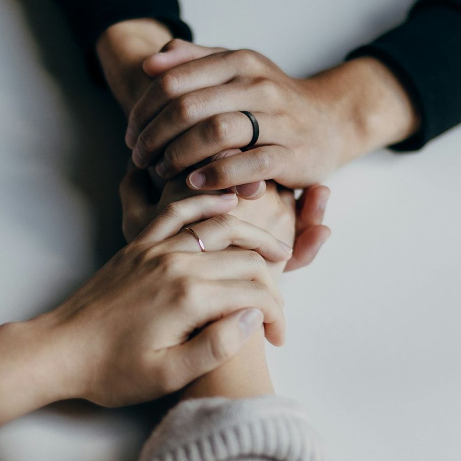 Two people holding hands, representing therapeutic support